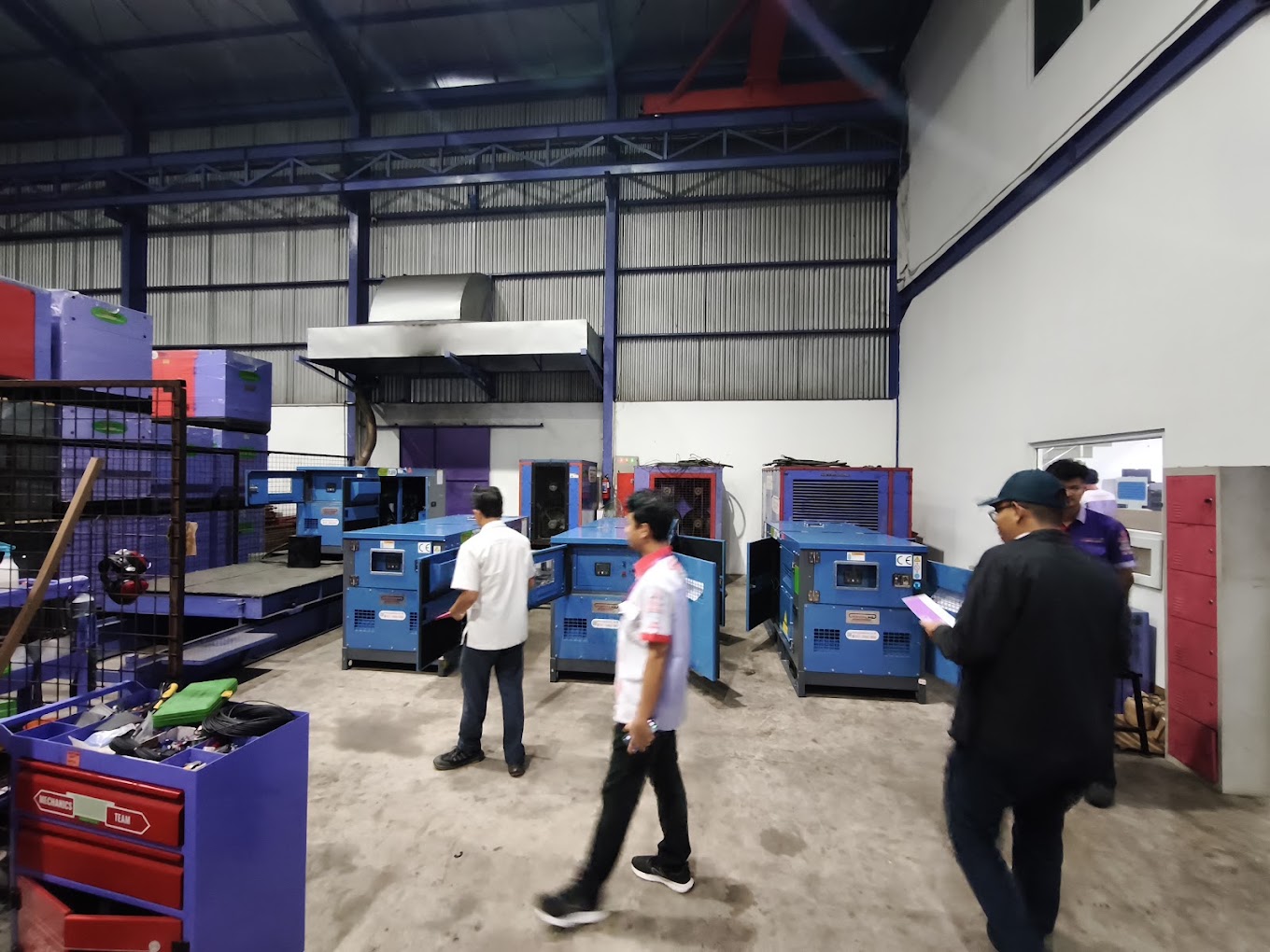 Walking the client&rsquo;s workshop during the operational walkthrough &mdash; generator sets open for inspection